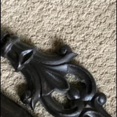 Two wrought iron corner curtain rods