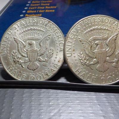 2 -1964 Kennedy half dollar coins.