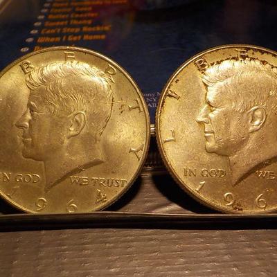 2 -1964 Kennedy half dollar coins.