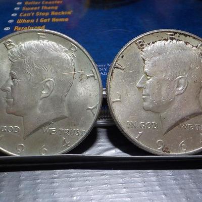 2 -1964 Kennedy half dollar coins.