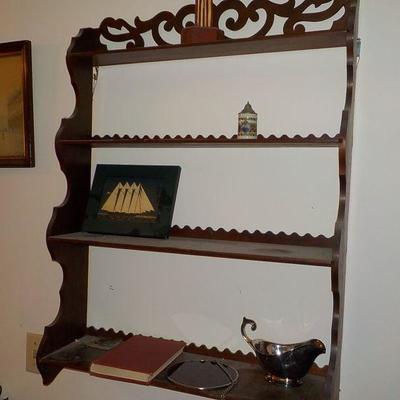 Hanging solid wood book or nic/nac shelve with articulate scroll design.
