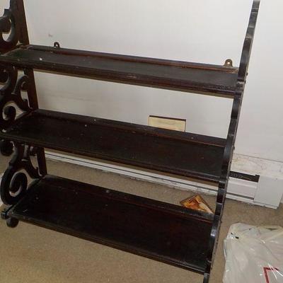 Hanging solid wood book or nic/nac shelve with articulate scroll design.