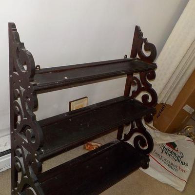 Hanging solid wood book or nic/nac shelve with articulate scroll design.