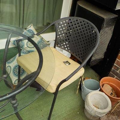 Solid  Wrought iron garden outside table and chairs/ glass top.