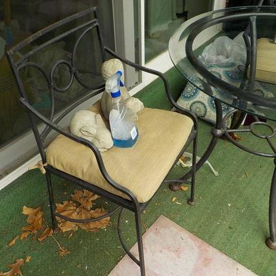Solid  Wrought iron garden outside table and chairs/ glass top.