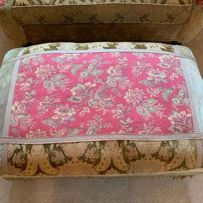 Haverty Love Seat with matching ottoman and side table with floral arrangement