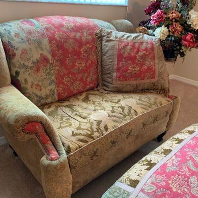 Haverty Love Seat with matching ottoman and side table with floral arrangement