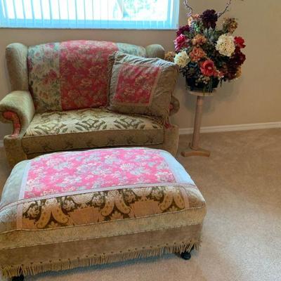 Haverty Love Seat with matching ottoman and side table with floral arrangement