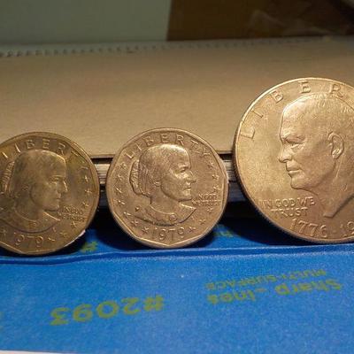Eisenhower Centennial dollar and 2 Susan B. Anthony silver dollars.