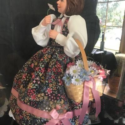Simpich Doll - Flower Girl - holding a flower to her nose with a basket of flowers
