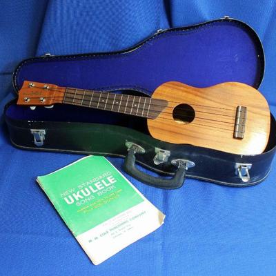 Lot 56: Rare Vintage Kamamke Hawaii Ukulele with Case and Book  $250