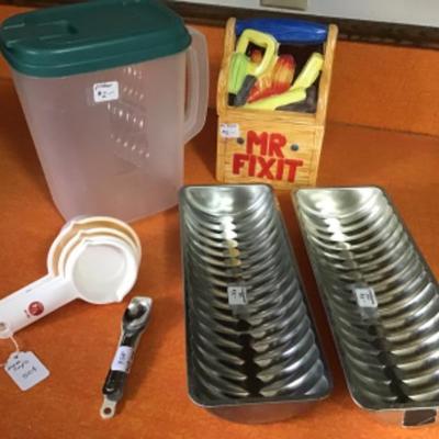 #k7. Mr. fix it cookie jar, two Swedish pans, pitcher and measuring cups