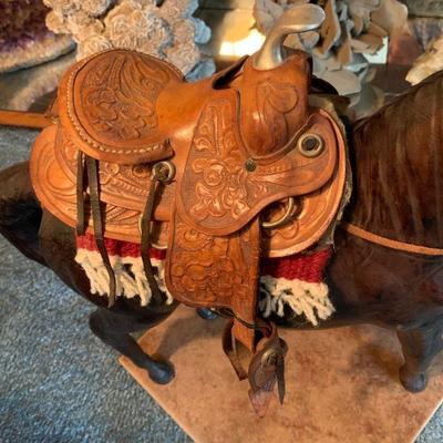 Horse sculpture with leather saddle 