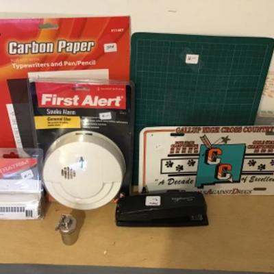 #tr48.  Smoke alarm, stapler, ultra trim, license plate, cutting mat