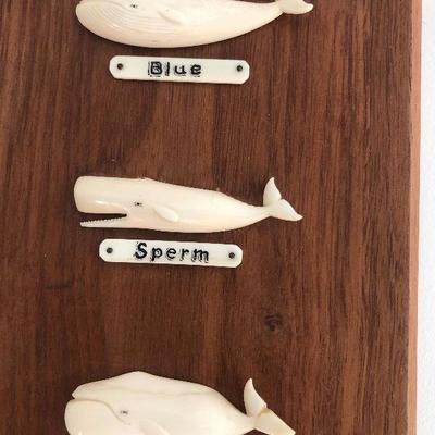 Aletha Macy Hand Carved Whale Figurines on Mahogany 