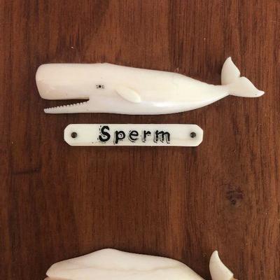 Aletha Macy Hand Carved Whale Figurines on Mahogany 