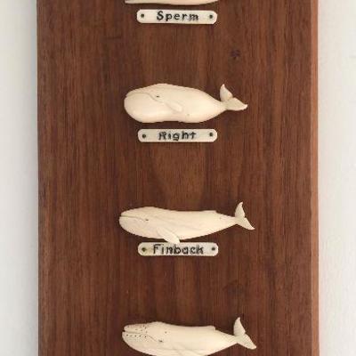 Aletha Macy Hand Carved Whale Figurines on Mahogany 