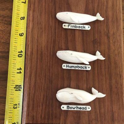 Aletha Macy Hand Carved Whale Figurines on Mahogany 