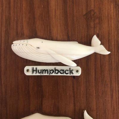 Aletha Macy Hand Carved Whale Figurines on Mahogany 