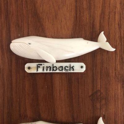 Aletha Macy Hand Carved Whale Figurines on Mahogany 