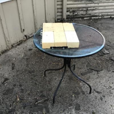 #a147. Metal outdoor table with bricks