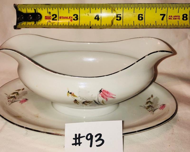 Flowered gravy boat attached to plate