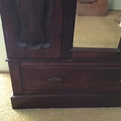B3-101 Antique armoire nicely carved with beveled mirror