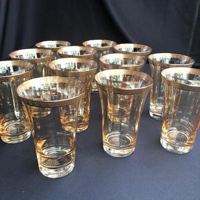 Set of 12 Gold iridescent Glasses with Gilt Trim.