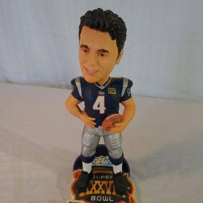 Adam Vinatieri bobblehead and Doug Flutie hat