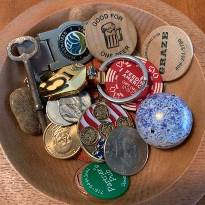 Bowl of beer tokens and coins