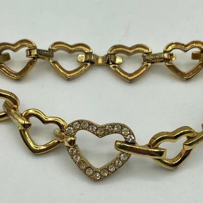 Gold tone bracelet with heart shaped links and faux diamonds 