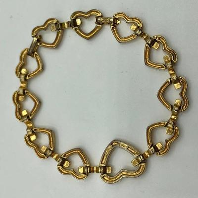 Gold tone bracelet with heart shaped links and faux diamonds 
