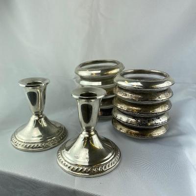 Lot # 230 set of sterling coasters and Candlesticks 