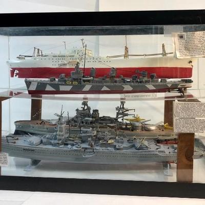 4 completed ship models inside of a customized aquarium 