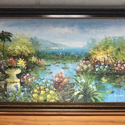 Large framed painting of lagoon or lake with lily pads, flowers, and palm trees