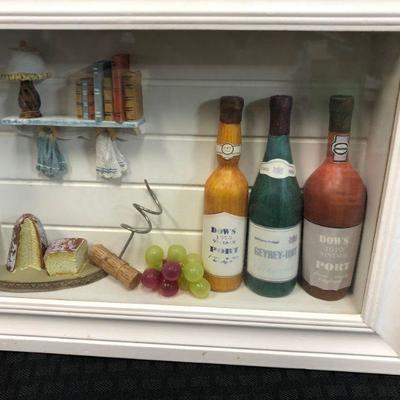 Miniature Kitchen Scene in 3D white frame with small bottles, miniature bread, wine grapes, corkscrew and shelf