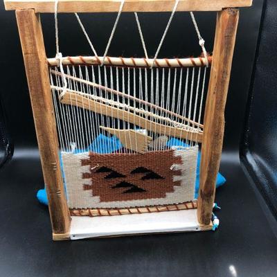 American Indian figurine using loom 