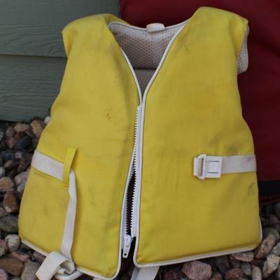 Lot 126: Vintage Stearnsâ„¢ Red Adult and Yellow Pee-Wee Safety Water Vests