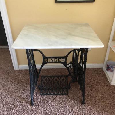 SINGER sewing table with marble top.
