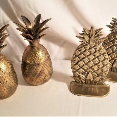 Lot #24  Decorative Solid Brass lot - pair of bookends and two figural pineapples
