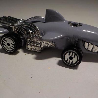 Cool police hot wheel and ultra shark mobile.