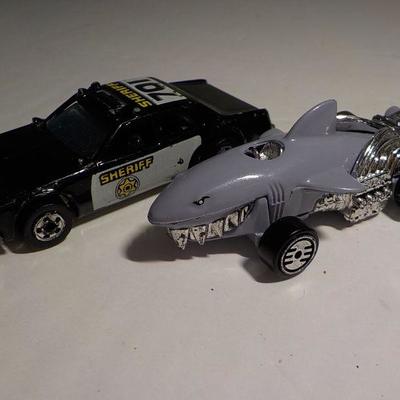 Cool police hot wheel and ultra shark mobile.