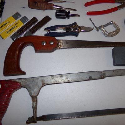 LOT 129  HAND SAWS, LEVELS, PLIERS, NUT DRIVERS AND MORE