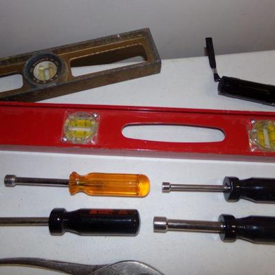 LOT 129  HAND SAWS, LEVELS, PLIERS, NUT DRIVERS AND MORE