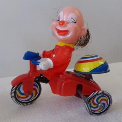 LOT 175  VINTAGE WIND UP TRICYCLE RIDING CLOWN