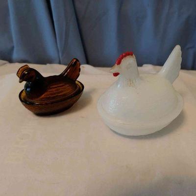 2 glass chickens (amber and white)