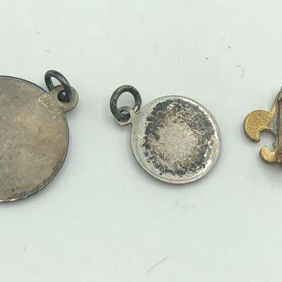 St. Christopher medals and Fleur-de-lis pin