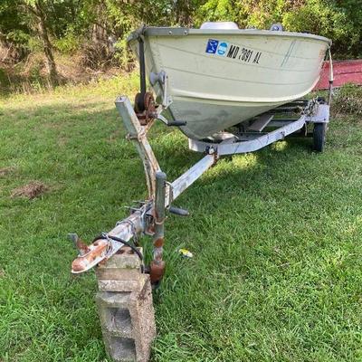 Lot # 610 Grumman 14’ Boat with NIssan Motor and Trailer 