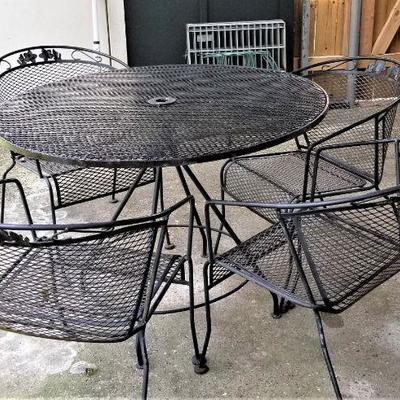 Lot #74  Classic Cast Iron Patio set - table and four chairs