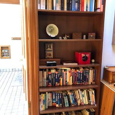 Tall Bookshelf with Assorted Books and Decor Items